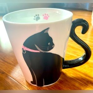 Black cat tea cup with tail for handle, paw prints inside